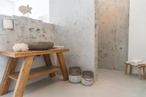 a bathroom with a wooden table and a sink at Aretousa Deluxe Downtown Apartment in Skala +25 photos