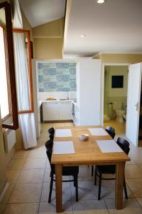 a dining room with a table and chairs and a kitchen at Bright Loft in Cannes