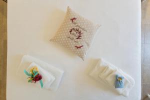 a white table with three napkins on it at il Giardino delle Zie in Tricase +44 photos