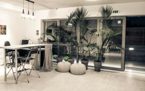 an office with potted plants in a room at Hotel Vozina in Metamorfosi