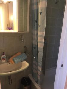 a bathroom with a shower curtain and a sink at Rooms Tusculum in Opatija +19 photos