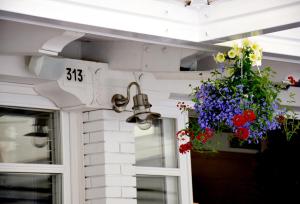 a door with a number and flowers on it at Hotel Ristorante Fortuna in Cavallino-Treporti