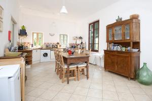 a large kitchen with a table and chairs in it at A House In Tuscany in Bagnone