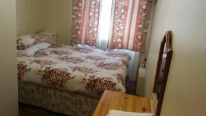 a small bedroom with a bed and a window at Stanley House Hotel in London