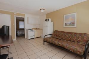 a living room with a couch and a kitchen at Sea Garden Motel in Seaside Heights