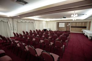 a conference room with chairs and a podium in it at Centrepoint Motor Inn in Rockhampton