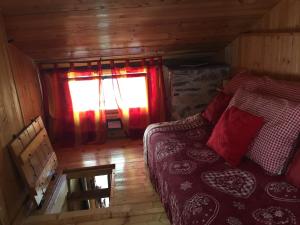 an attic room with a bed and a window at La Maison des Fées in Mex