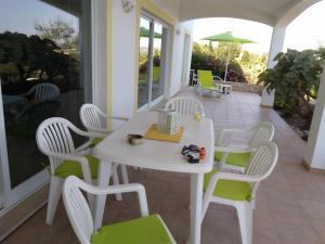 a white table and chairs on a patio at Villa Casa do Monte in Silves