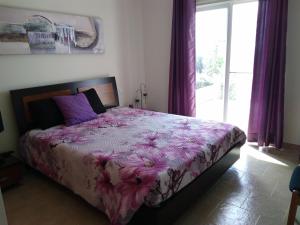 a bedroom with a large bed with a purple comforter at Villa Casa do Monte in Silves +27 photos