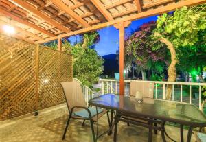 a patio with a table and chairs and a fence at Stefanos Studios in Keri