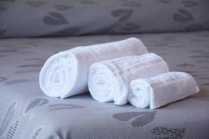 two rolled towels sitting on top of a bed at Hotel Ristorante Fortuna in Cavallino-Treporti