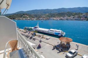 a boat is docked in a large body of water at Hotel Saron in Poros