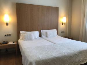 Postel nebo postele na pokoji v ubytování Hotel Entredos