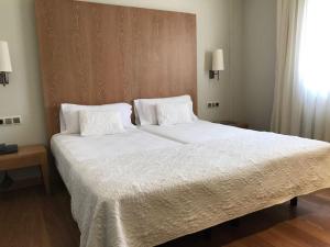 Postel nebo postele na pokoji v ubytování Hotel Entredos