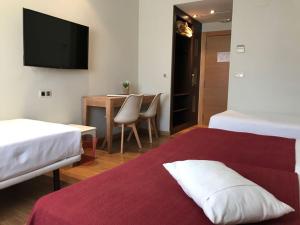 Postel nebo postele na pokoji v ubytování Hotel Entredos