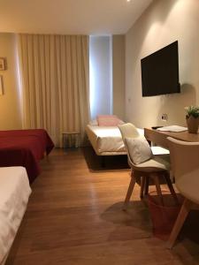 Postel nebo postele na pokoji v ubytování Hotel Entredos
