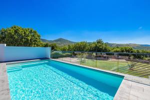 een zwembad in een villa met uitzicht bij Villa Krasica - Private Tennis Court, Sauna & Jacuzzi in Krasica