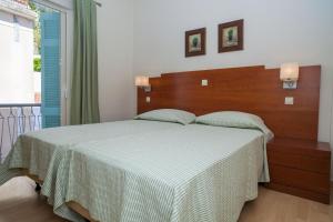 Postel nebo postele na pokoji v ubytování Hotel Saron