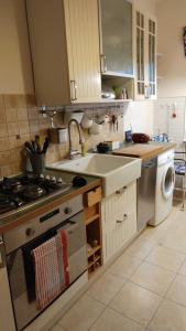 a kitchen with a sink and a stove top oven at W kamienicy in Gdańsk