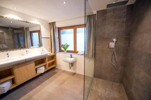 a bathroom with a sink and a shower at Chalet & Apartments Tiroler Bua in Achenkirch