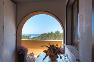 a dining room with a table and a view of the ocean at Residence Blue Pearl in Marina di Camerota