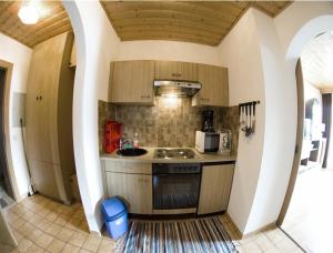 a kitchen with a stove and a sink in a room at Ferienwohnung Moser am See in Millstatt