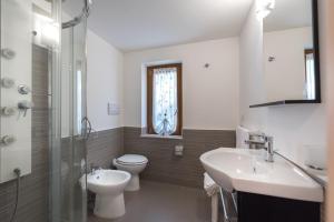 a bathroom with a toilet and a sink and a mirror at Residence Blue Pearl in Marina di Camerota +20 photos