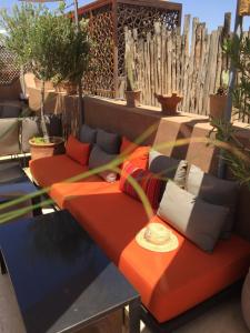a group of couches with pillows on a patio at Riad Dar 73 in Marrakesh