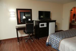 a hotel room with a bed and a desk with a computer at Budget Inn - Washington in Washington