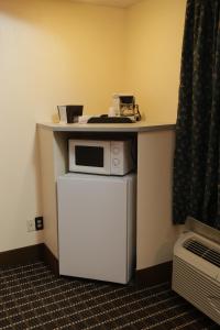 a table with a microwave on top of a refrigerator at Budget Inn - Washington in Washington