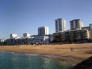 a beach with tall buildings in the background of a city at 180° Sea View - Fabulosa vista mar! in Quarteira