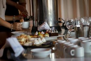 a table with a plate of food and wine glasses at Hotel Dos Venados in San Luis