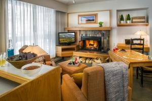 a living room with a couch and a fireplace at Inn at Snowbird in The Cliff Lodge