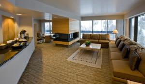 a large living room with a couch and a table at Inn at Snowbird in The Cliff Lodge