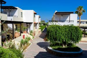 a walkway through the courtyard of a building at Pefkos Village Resort in Pefki