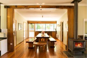 a living room with a fireplace and a stove at Riverbend Homestead in Bright