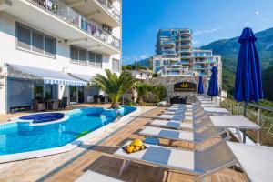 a hotel with a pool and a building at Montelux Apartments in Budva