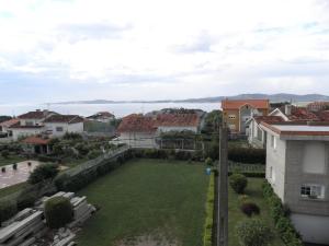 a view from the roof of a house with a large yard at Novas Foxos (Ático) in A Lanzada