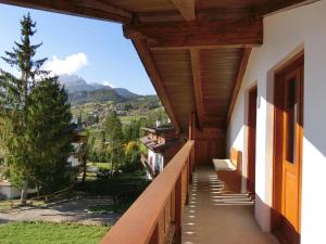 a balcony of a house with a view of the mountains at Attico Castello in Cortina dʼAmpezzo