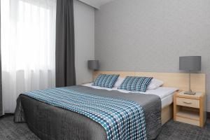 Posteľ alebo postele v izbe v ubytovaní Hotel Perła