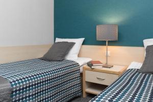 Posteľ alebo postele v izbe v ubytovaní Hotel Perła