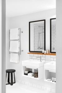 a bathroom with two sinks and a mirror at Ovolo Laneways in Melbourne