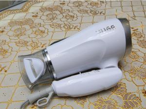 a hair dryer sitting on top of a table at Minshuku Tantawan -SEVEN Hotels and Resorts- in Motobu