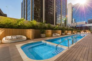 a swimming pool on the rooftop of a building at One Global Resorts Parramatta in Sydney