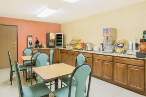 a restaurant with tables and chairs and a counter at Days Inn by Wyndham Phoenix North in Phoenix