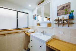 a bathroom with a sink and a window at The Blue Beach House in Quinns Rocks +9 photos