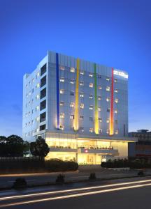 a large building with lights on the side of it at Amaris Hotel Serpong Tangerang in Serpong