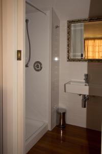 uma casa de banho com um chuveiro e um lavatório. em Cheltenham House em Hanmer Springs