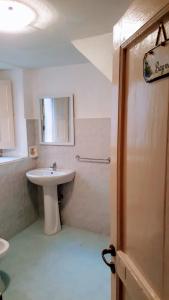 a bathroom with a sink and a toilet and a mirror at Albergo Diffuso Borgo Santa Caterina "Quartire Hebraic" in Castiglione di Sicilia