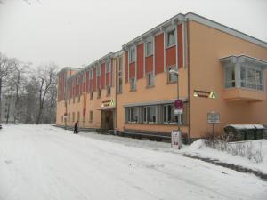 a person standing outside of a building in the snow at Jugendherberge Karlsruhe in Karlsruhe